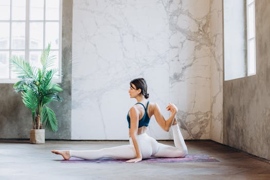 A woman performs yoga in a bright, modern space, embodying relaxation and mindfulness.