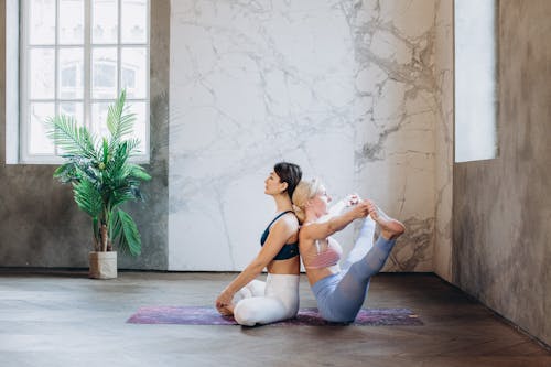 Free Women Practicing Yoga Stock Photo