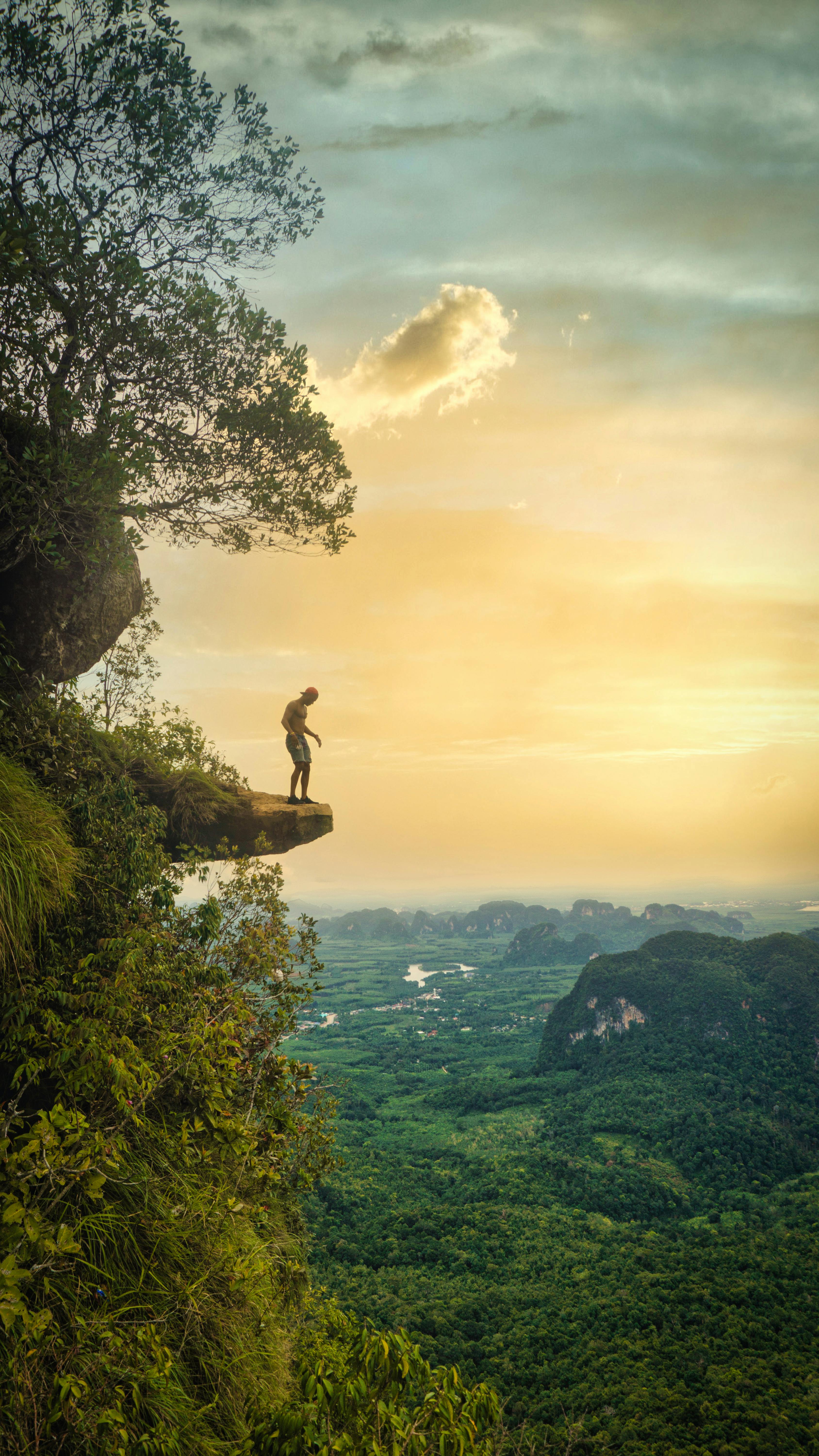 man standing on cliff edge