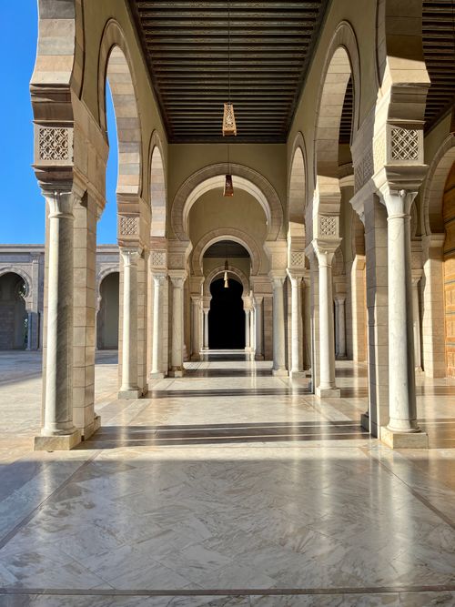 Free Beautiful sunlight casts shadows in a historical arched hallway in Tunis, showcasing traditional architecture. Stock Photo