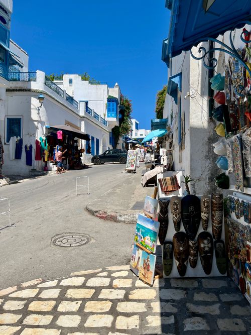 Free Vibrant street market in the historic Carthage, featuring local crafts under a clear blue sky. Stock Photo