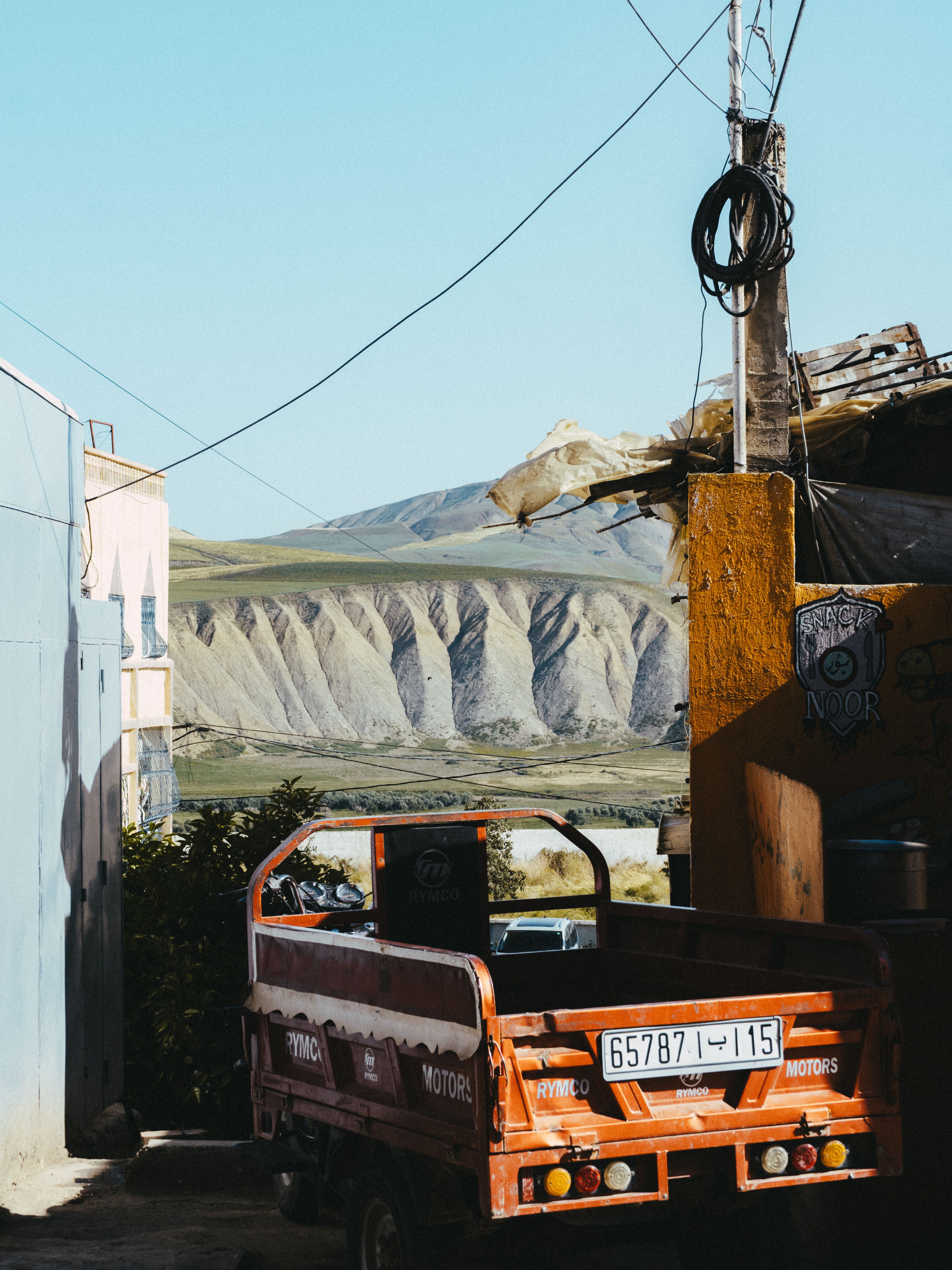Rustic street scene in Fes with a backdrop of stunning mountains.