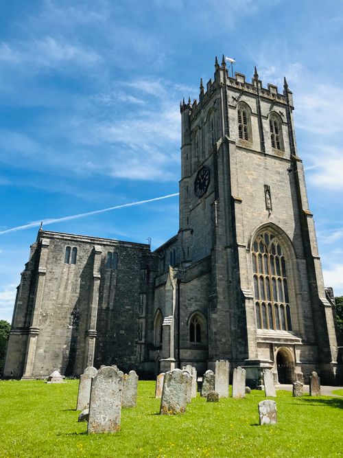 Free Beautiful daytime view of Christchurch Priory with blue skies and green grass. Stock Photo