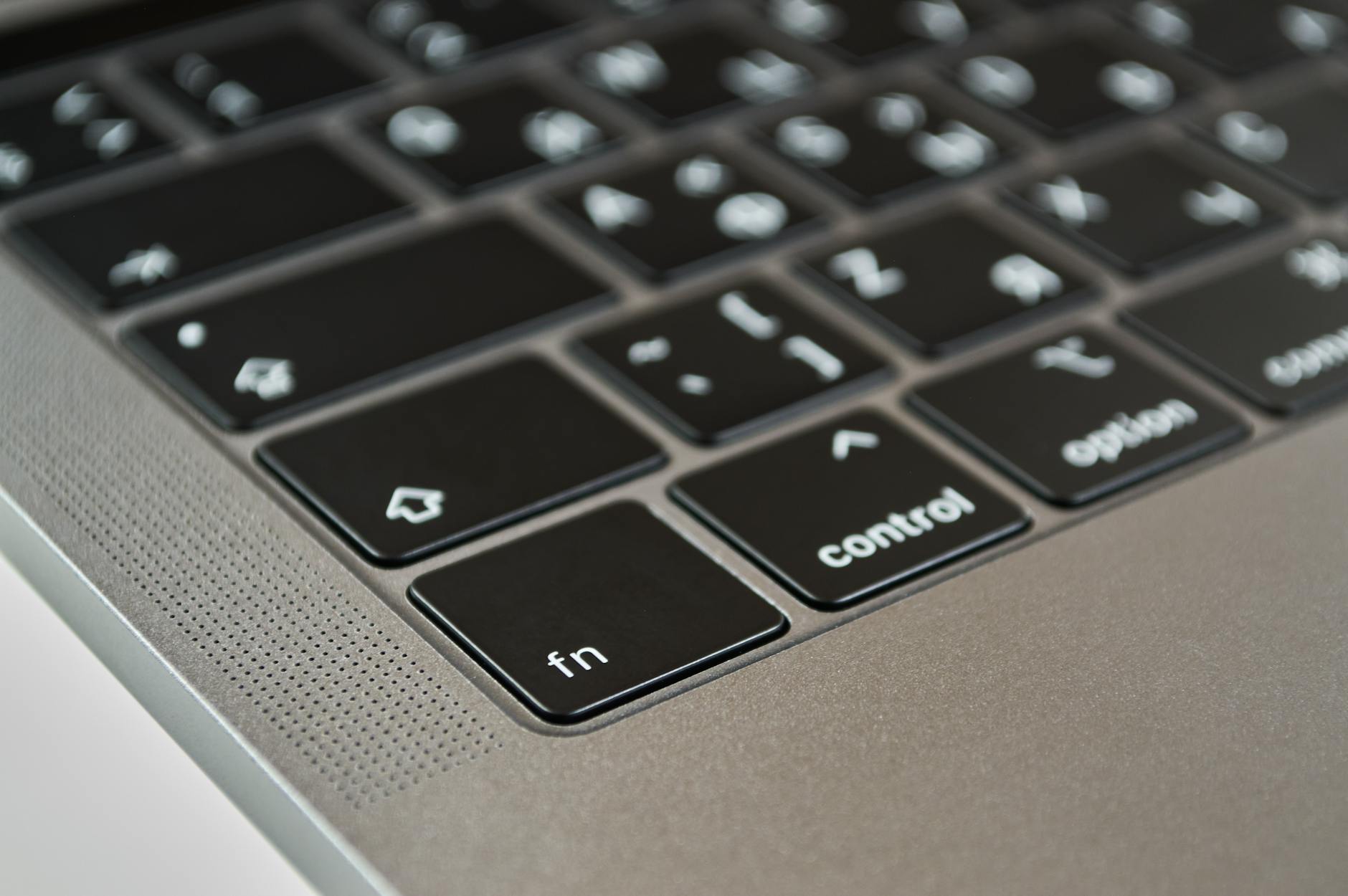 A detailed close-up of a modern laptop keyboard showcasing the fn and control keys with selective focus.