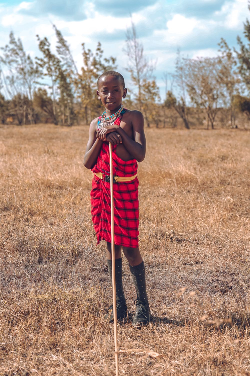 Maasai child in traditional dress on the plains