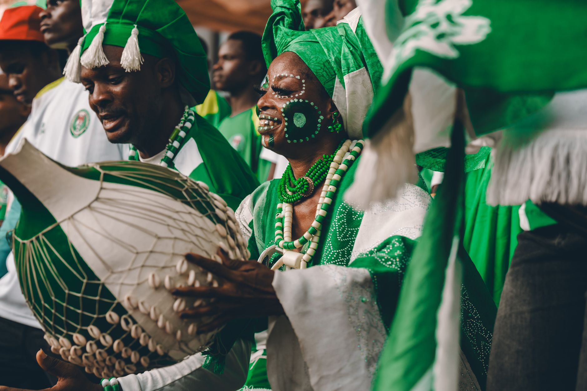 Vibrant scene of African drummers in traditional attire, enhancing a lively cultural celebration.