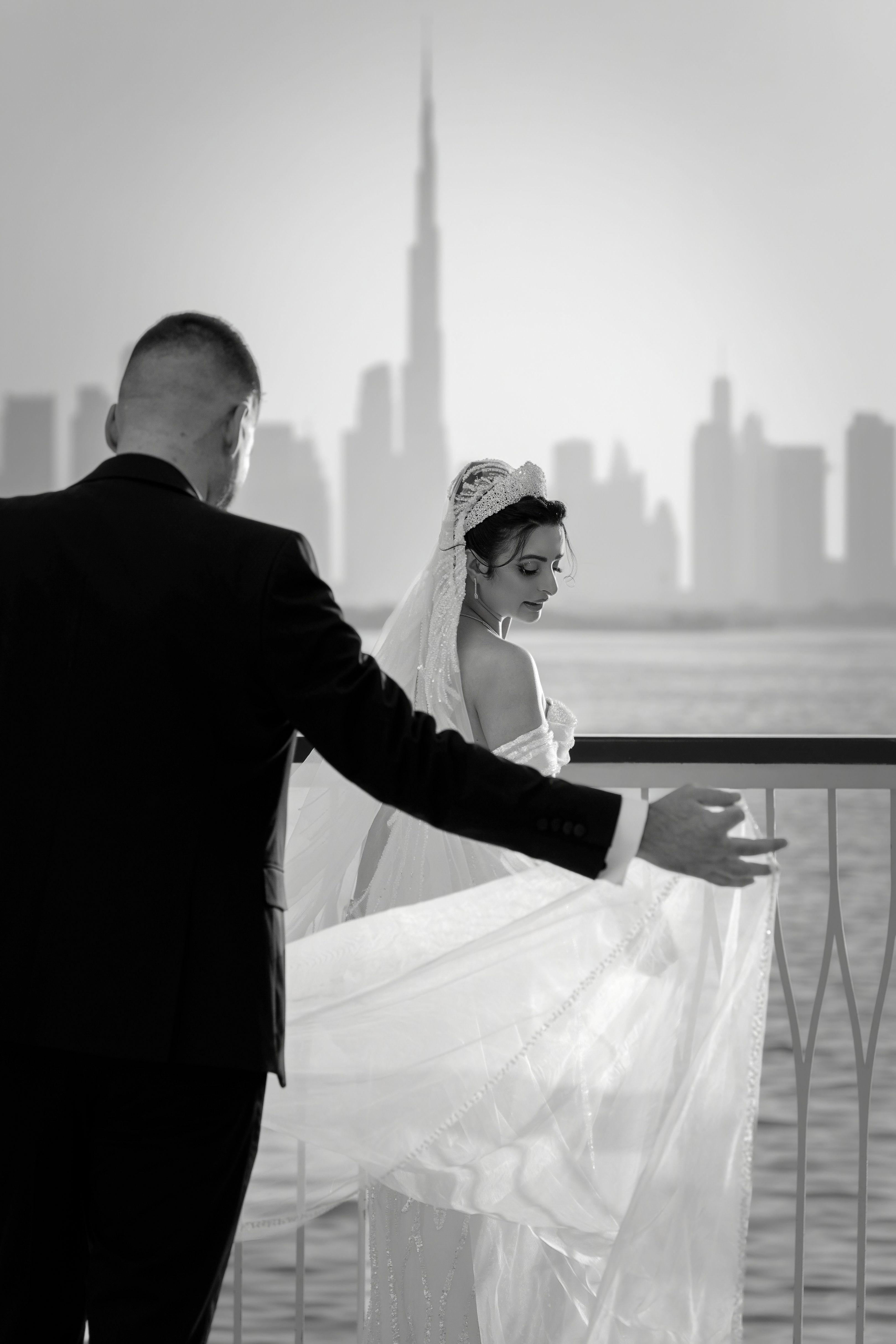 Elegant black and white wedding photo with the Burj Khalifa skyline in Dubai.