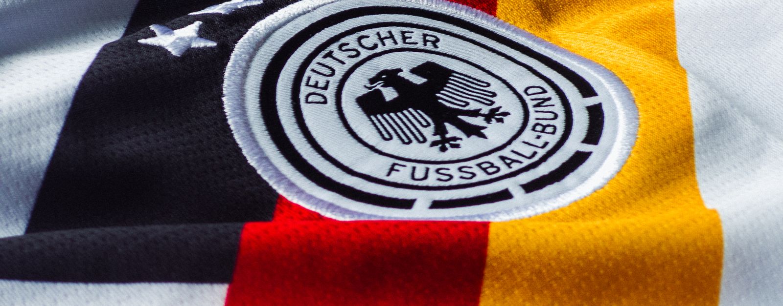 Detailed view of the German national football team jersey with emblem.