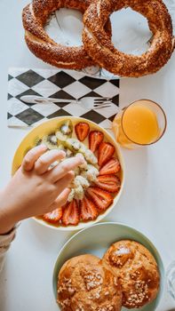 Bright and inviting breakfast with fresh fruit, orange juice, and pastries.