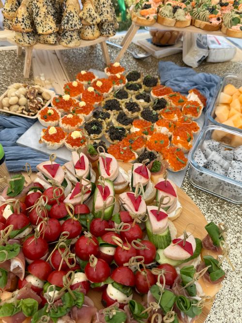Free Colorful array of hors d'oeuvres and snacks served at an outdoor catering event, showcasing diversity in gourmet options. Stock Photo