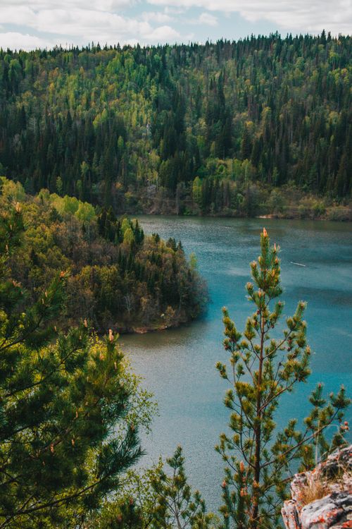 Free Serene landscape of a lake surrounded by lush forest in Russia. Stock Photo