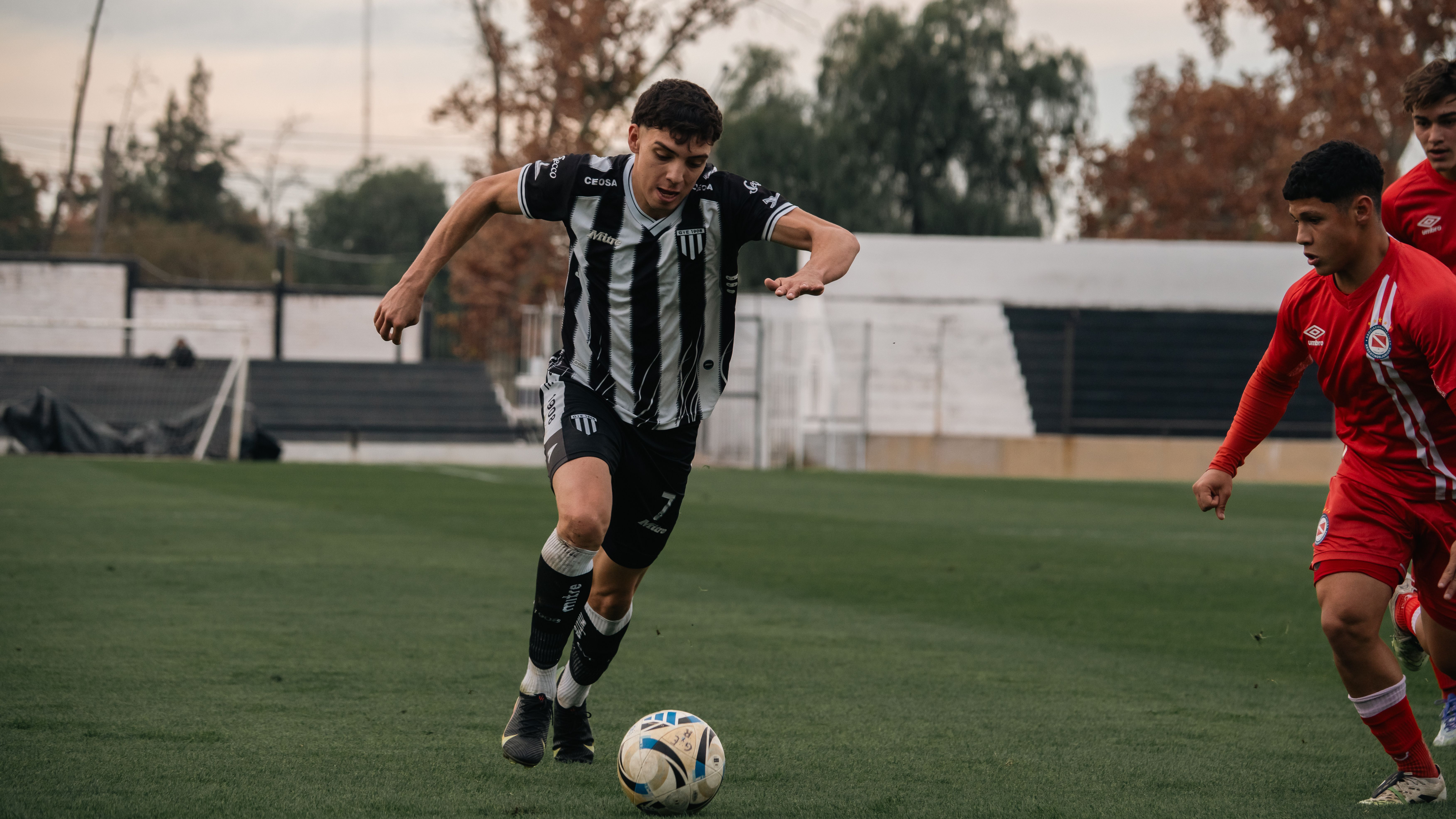 EPL photo featuring Soccer players in action during an outdoor match, showcasing skill and competition.