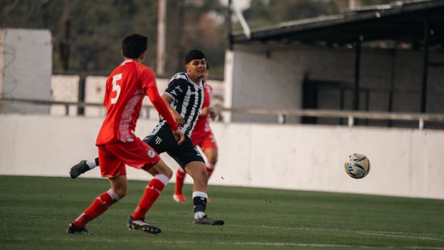 Two soccer players in action on the field, competing intensely during a match.