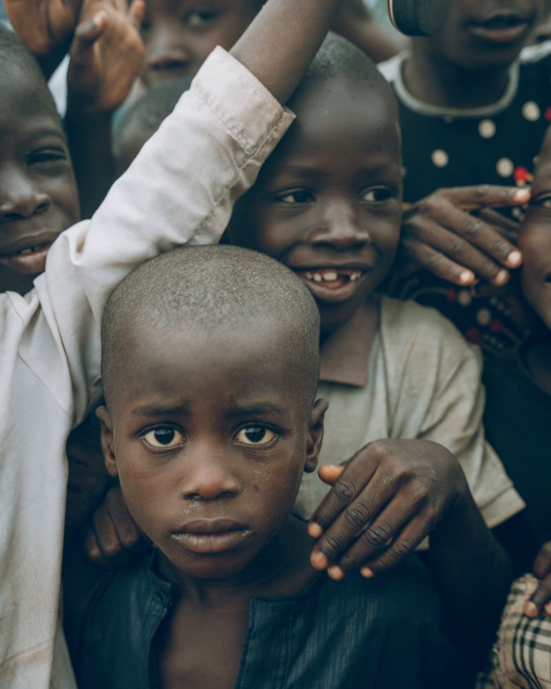 Smiling Nigerian children outdoors on campus