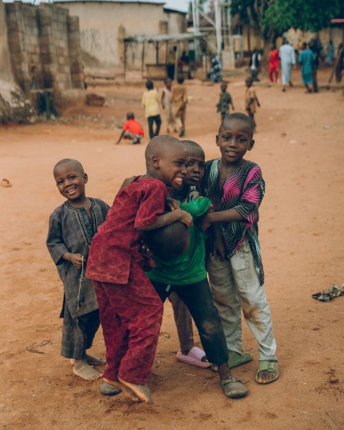 Free African children enjoying playtime in a Nigerian village, showcasing vibrant culture and joy. Stock Photo