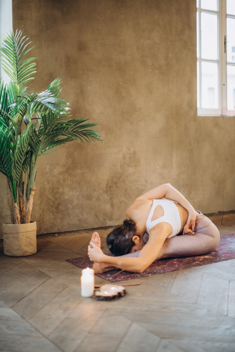 Woman in a gentle yoga pose in a bright room
