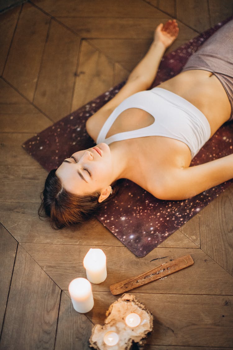 Woman Relaxing In Yoga Mat