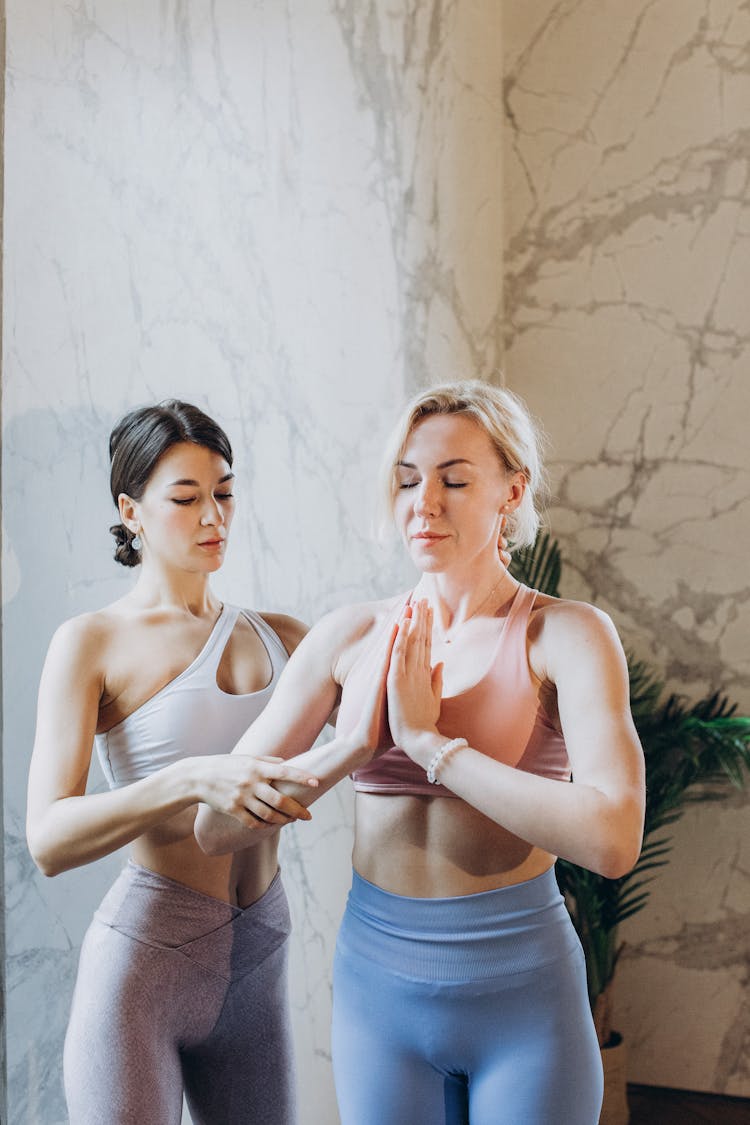 Yoga Instructor Helping A Student