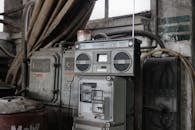 Old fashioned cassette player placed in shabby garage near old industrial equipment