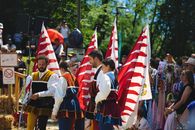 Colorful medieval costume parade during a sunny day festival in Kapfenberg, Austria.