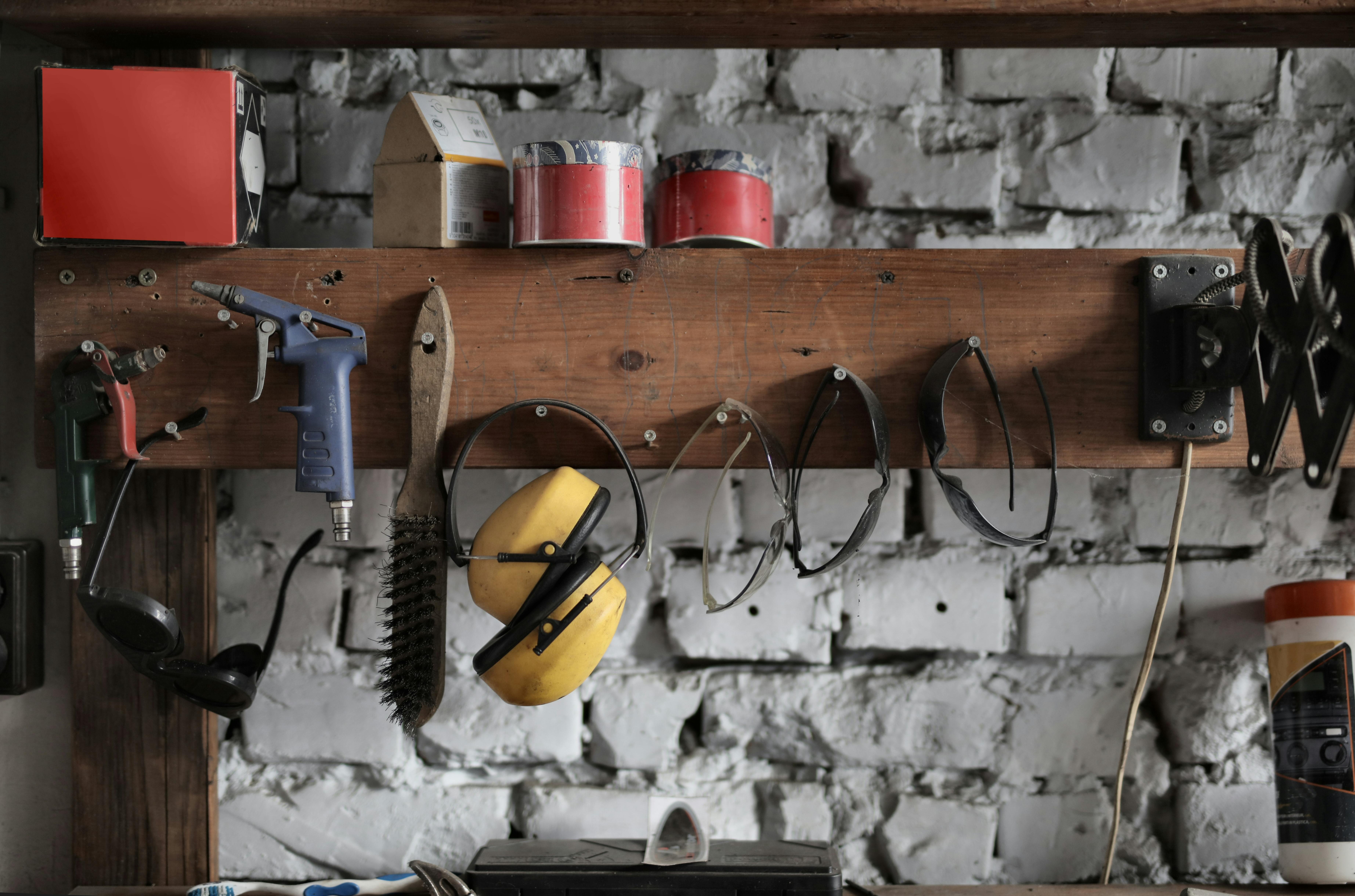 various instruments hanging on wooden board in garage