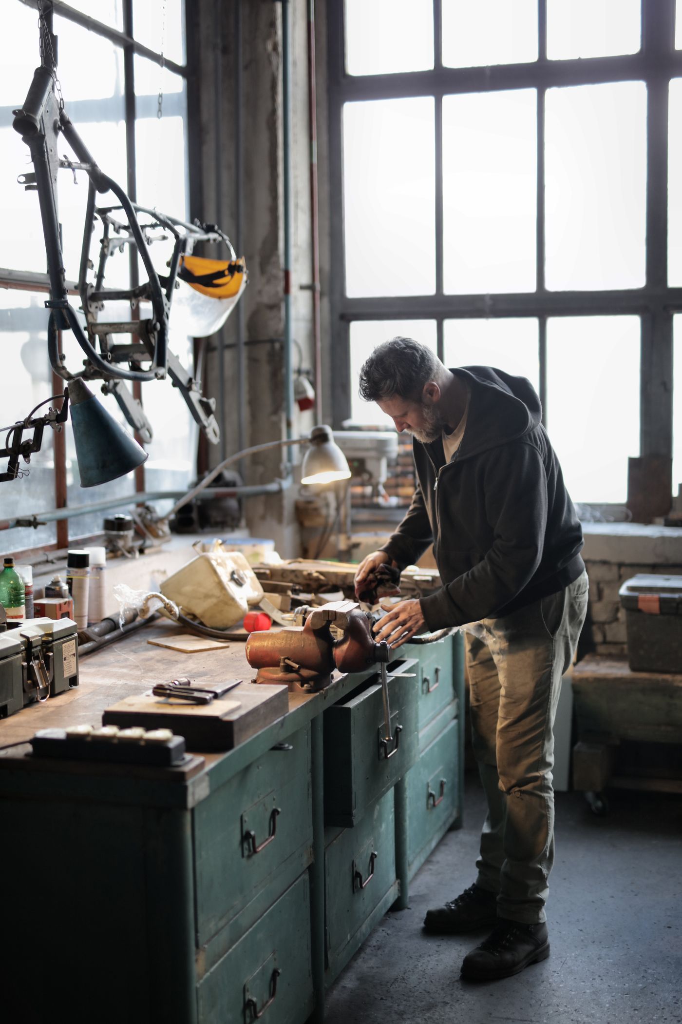 TorqueLab mechanic working on a metal component in the workshop