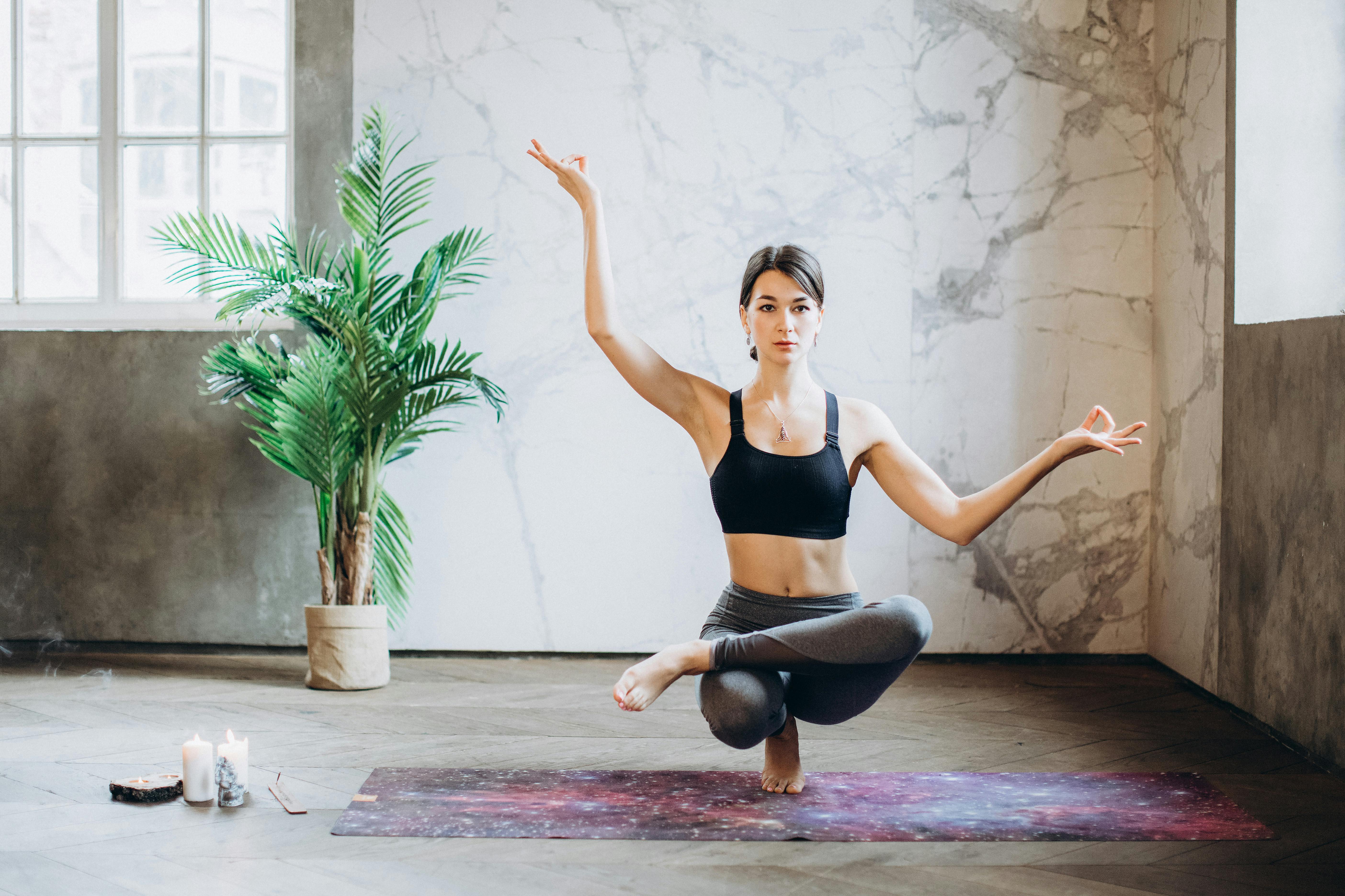 Young Woman Practicing a Yoga Stock Photo - PixelTote