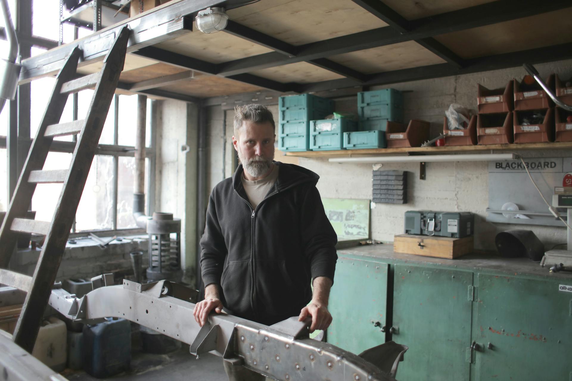 Brutal male mechanic in shabby workshop