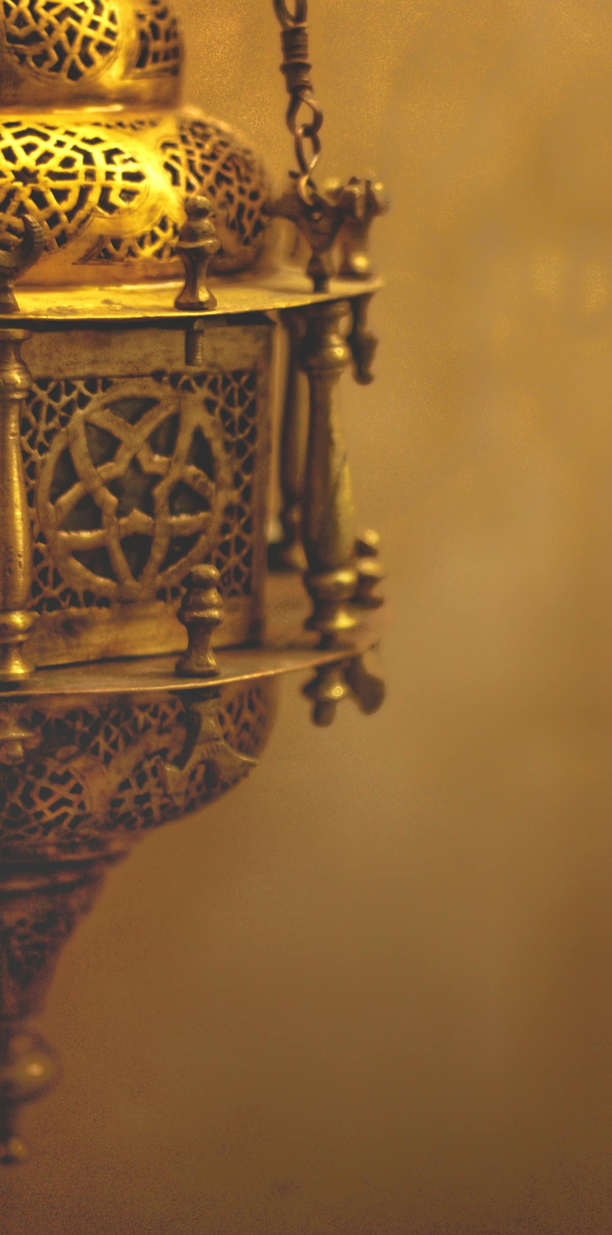 Person relaxing on a sofa with a warm drink, watching content on a laptop