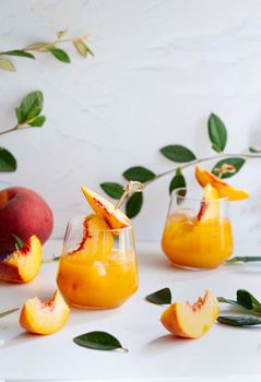 Bright peach cocktail with fresh garnishes, perfect for summer refreshments.