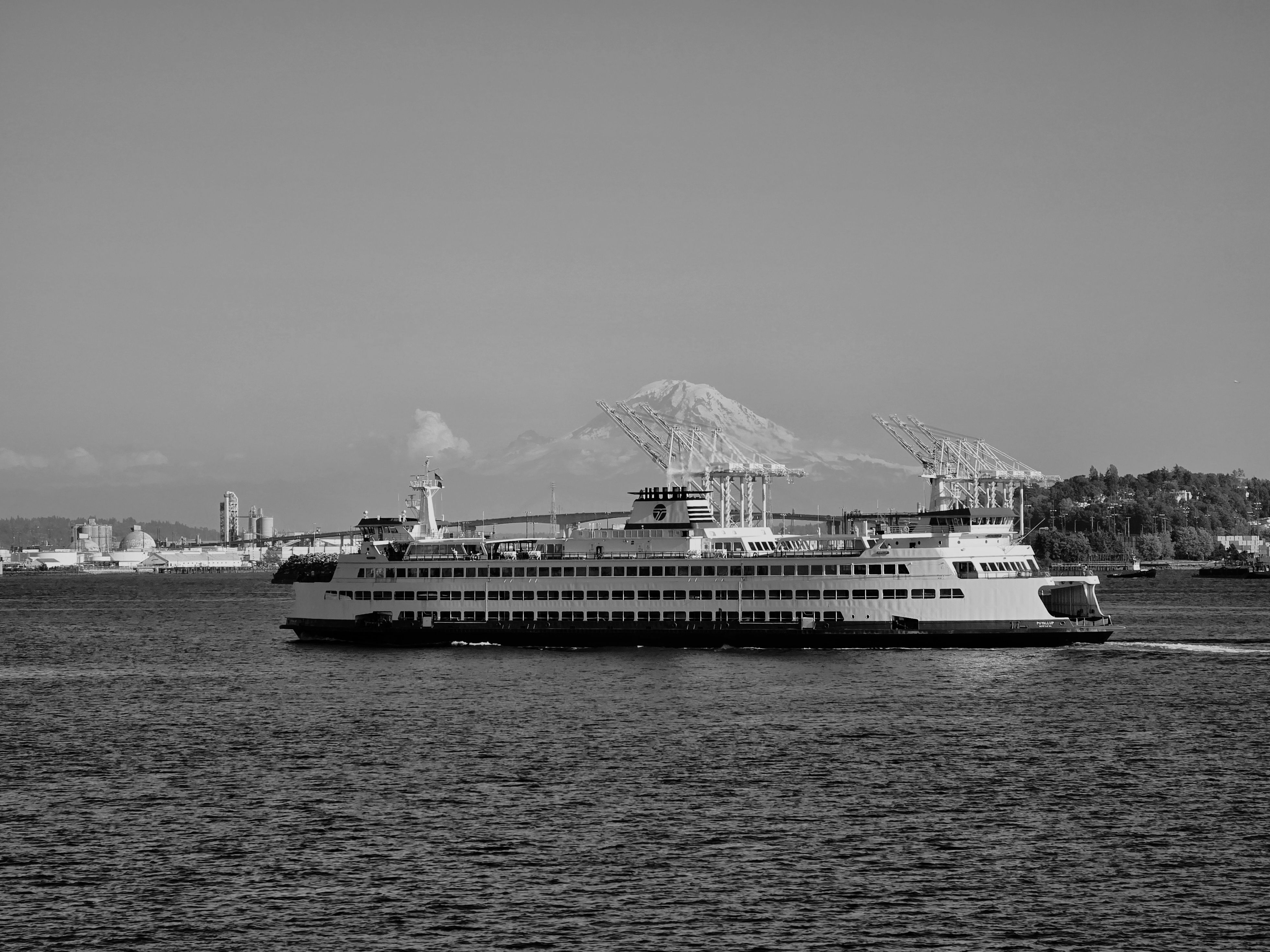 Black-and-white photo of a Seattle ferry with Mount Rainier rising in the distance.