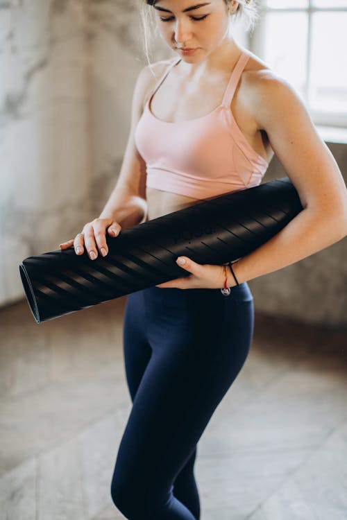 Woman Holding her Yoga Mat