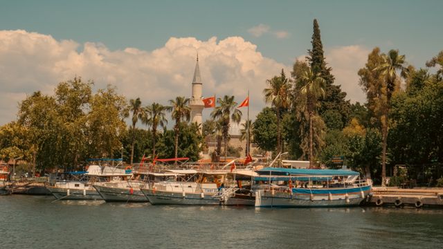 Charming view of boats docked by Boğaziçi Mosque in Dalaman, Türkiye, during a sunny summer day. — lounges at Dalaman Airport