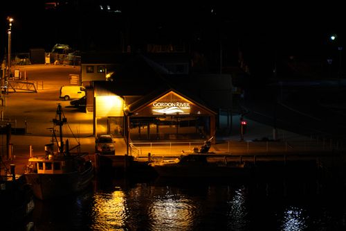 Free Illuminated Gordon River Cruise terminal at night in Strahan, Tasmania. Stock Photo