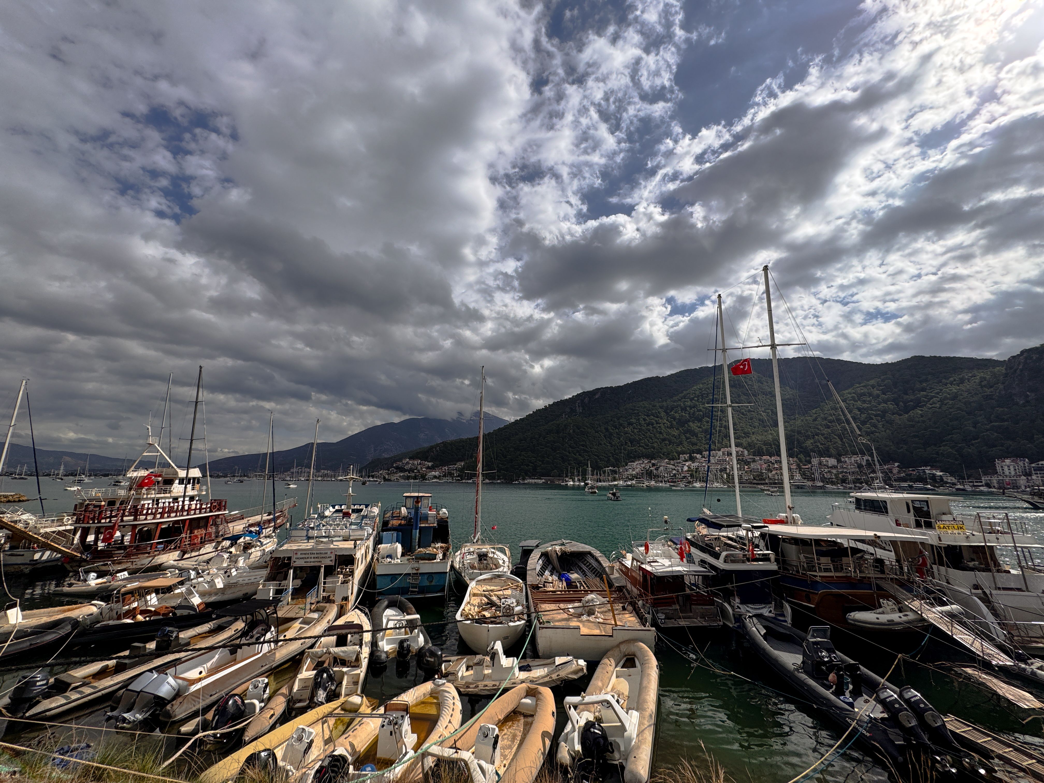 Unforgettable Alanya Starcraft Night Disco Yacht with Foam Party & Transfer Review 2026 - Explore the vibrant Fethiye Marina with moored boats under a dramatic cloudy sky.