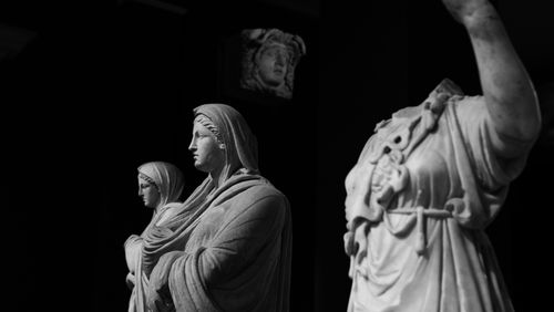 Ancient statues in a museum hall, black and white — photo by Mesut Yalcin on Pexels