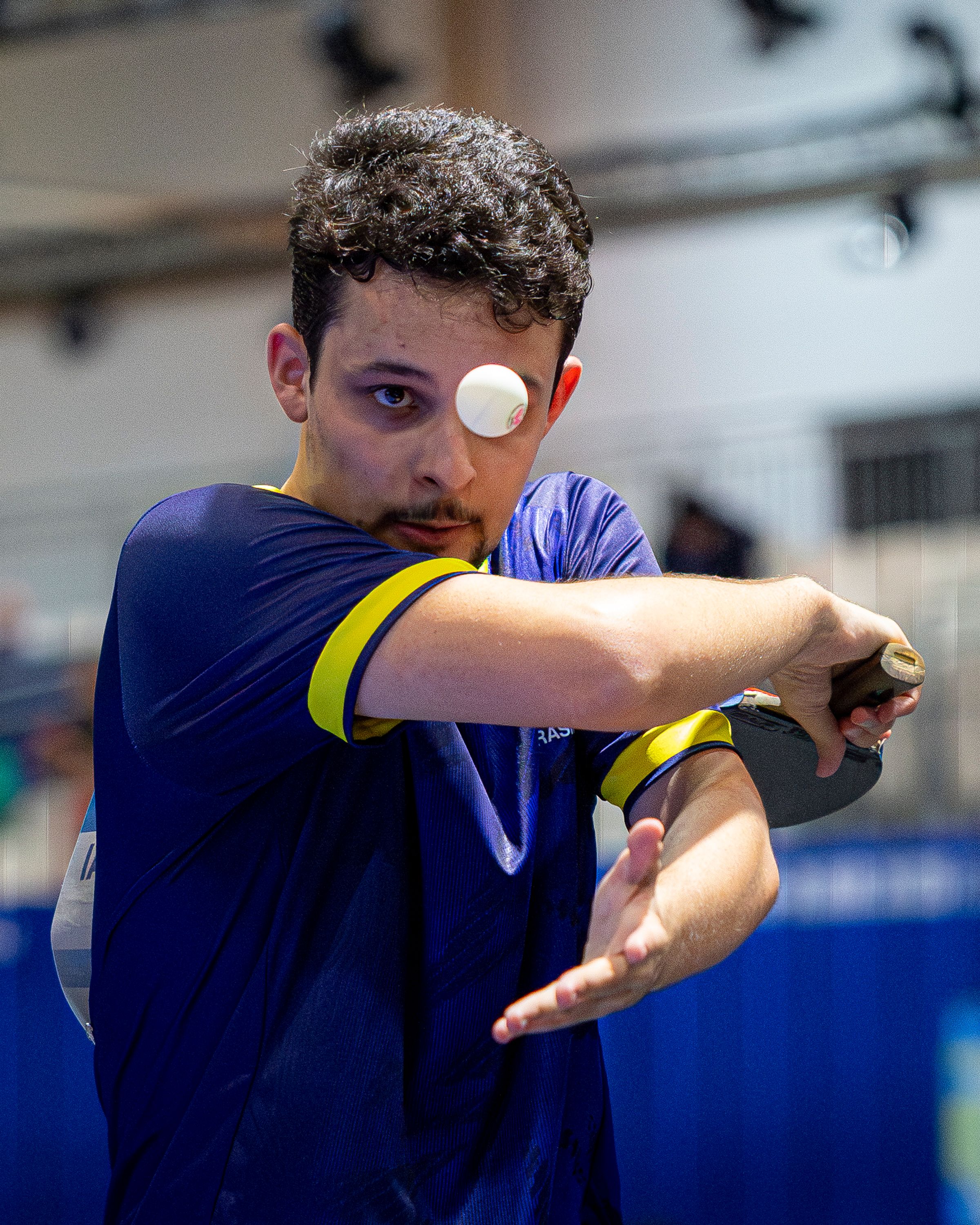 Dynamic shot of a man playing table tennis showcasing focus and skill.