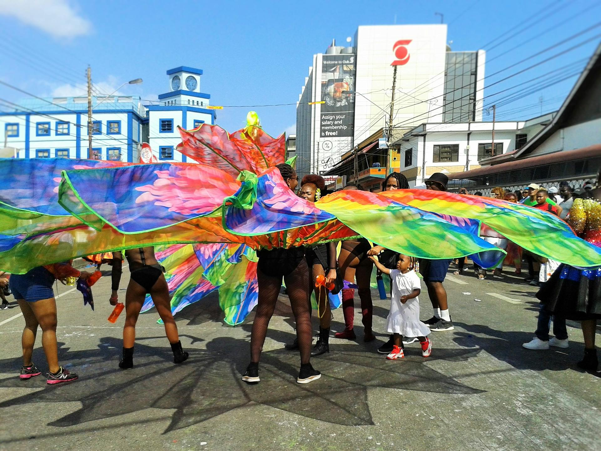 Colorful parade scene with people in costumes at the Trinidad and Tobago carnival in Port of Spain.