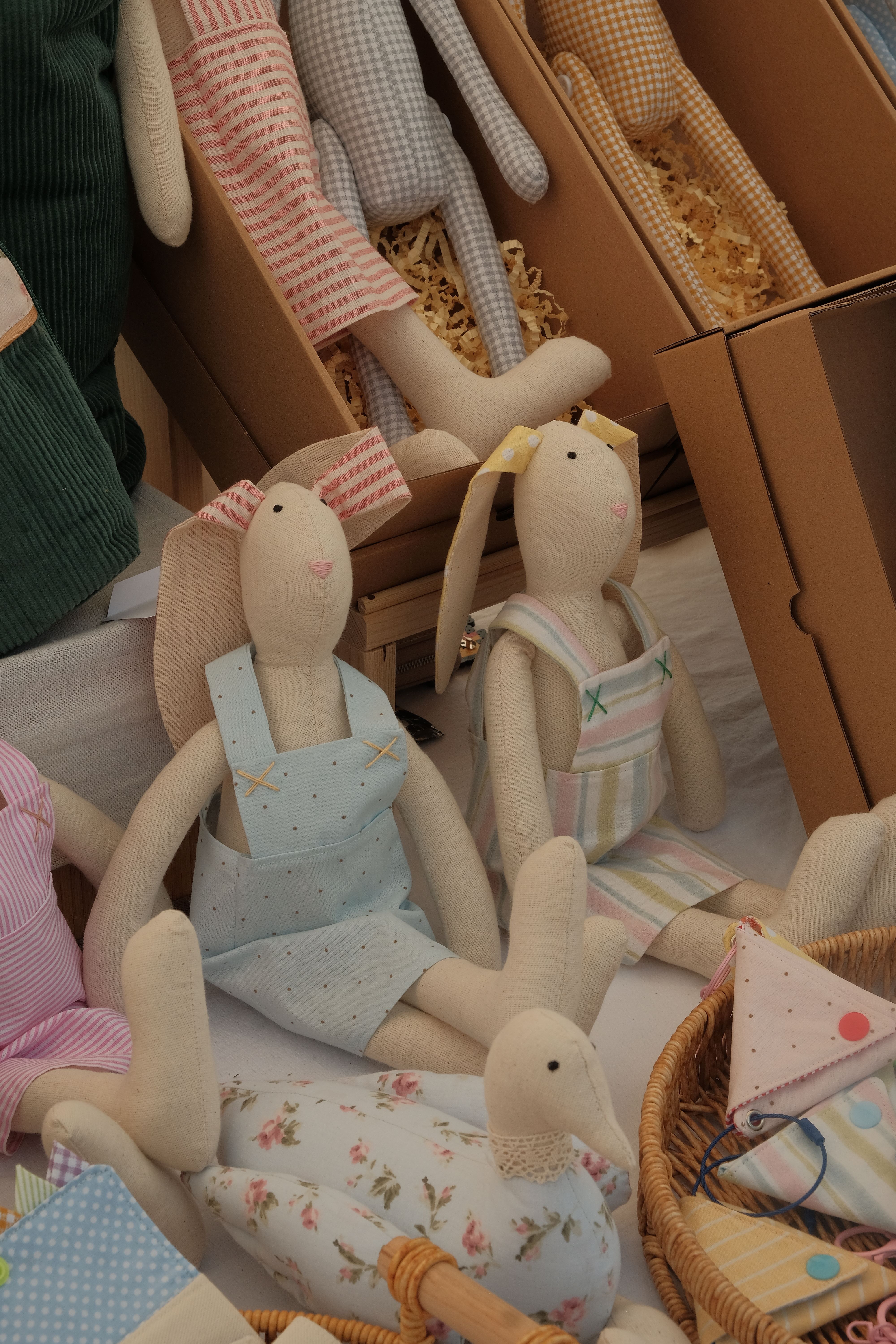Handmade fabric rabbit dolls in pastel clothing — photo by zeynepshoots on Pexels