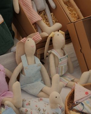 Handmade fabric rabbit dolls in pastel clothing — photo by zeynepshoots on Pexels