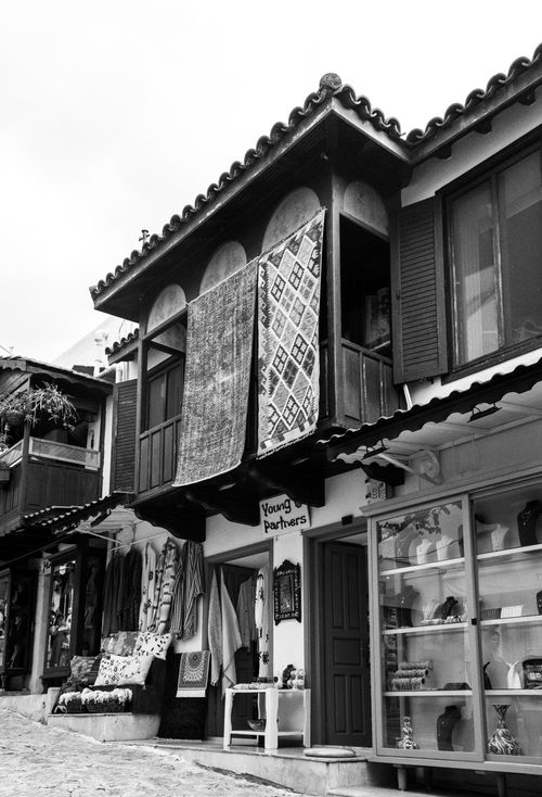 Free Black and white photo of traditional Middle Eastern street market with textiles on display. Stock Photo