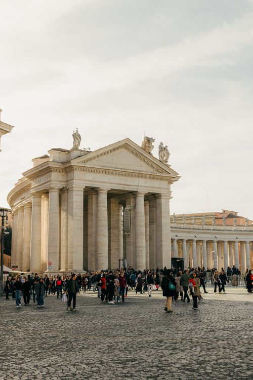 Free A bustling crowd at St. Peter's Square in Vatican City, showcasing iconic Roman architecture. Stock Photo