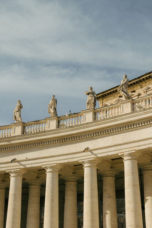 Free A detailed view of the statues and columns in Vatican City's iconic architecture. Stock Photo