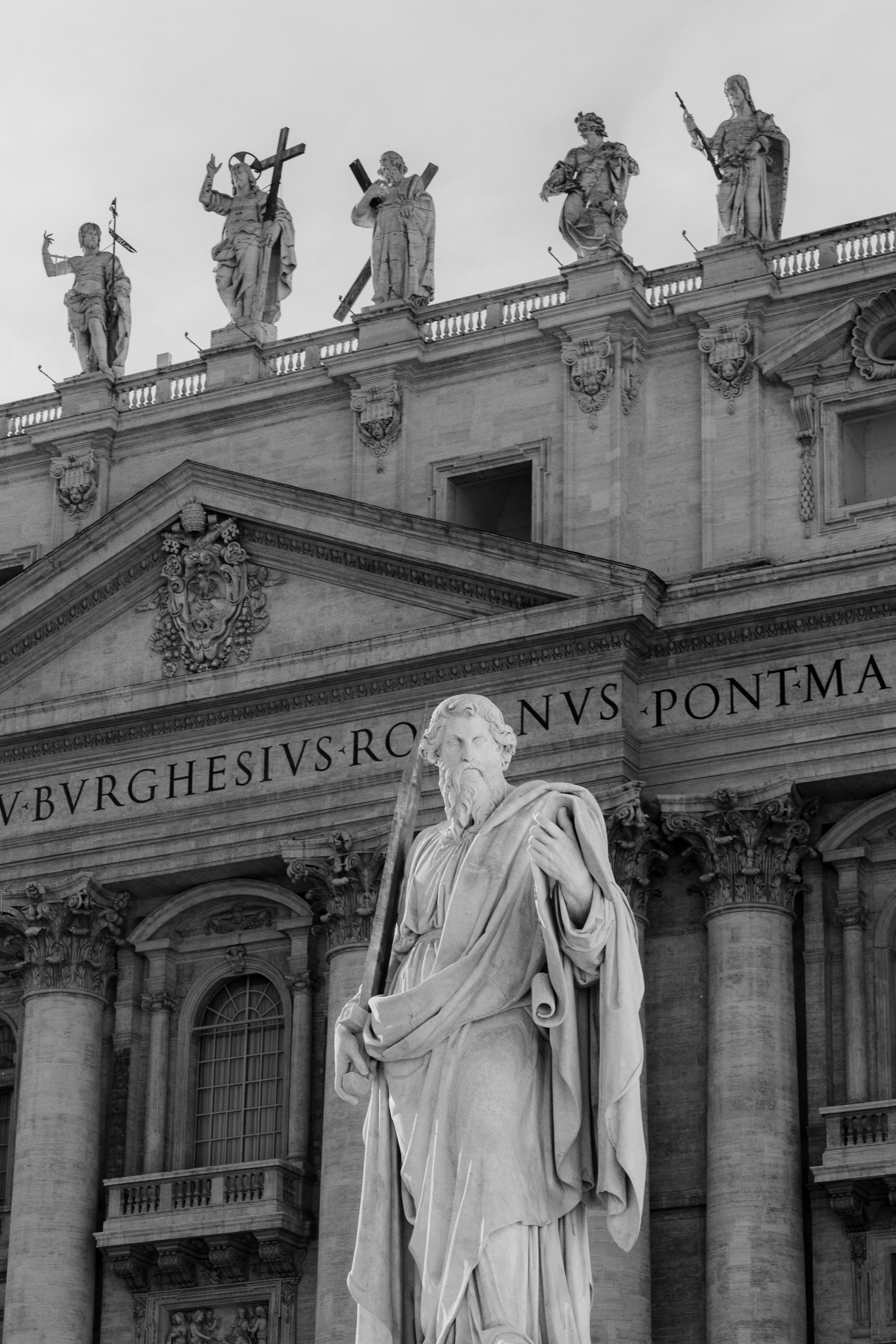 Black and white photo of St. Peter's Basilica statues capturing historic architecture.