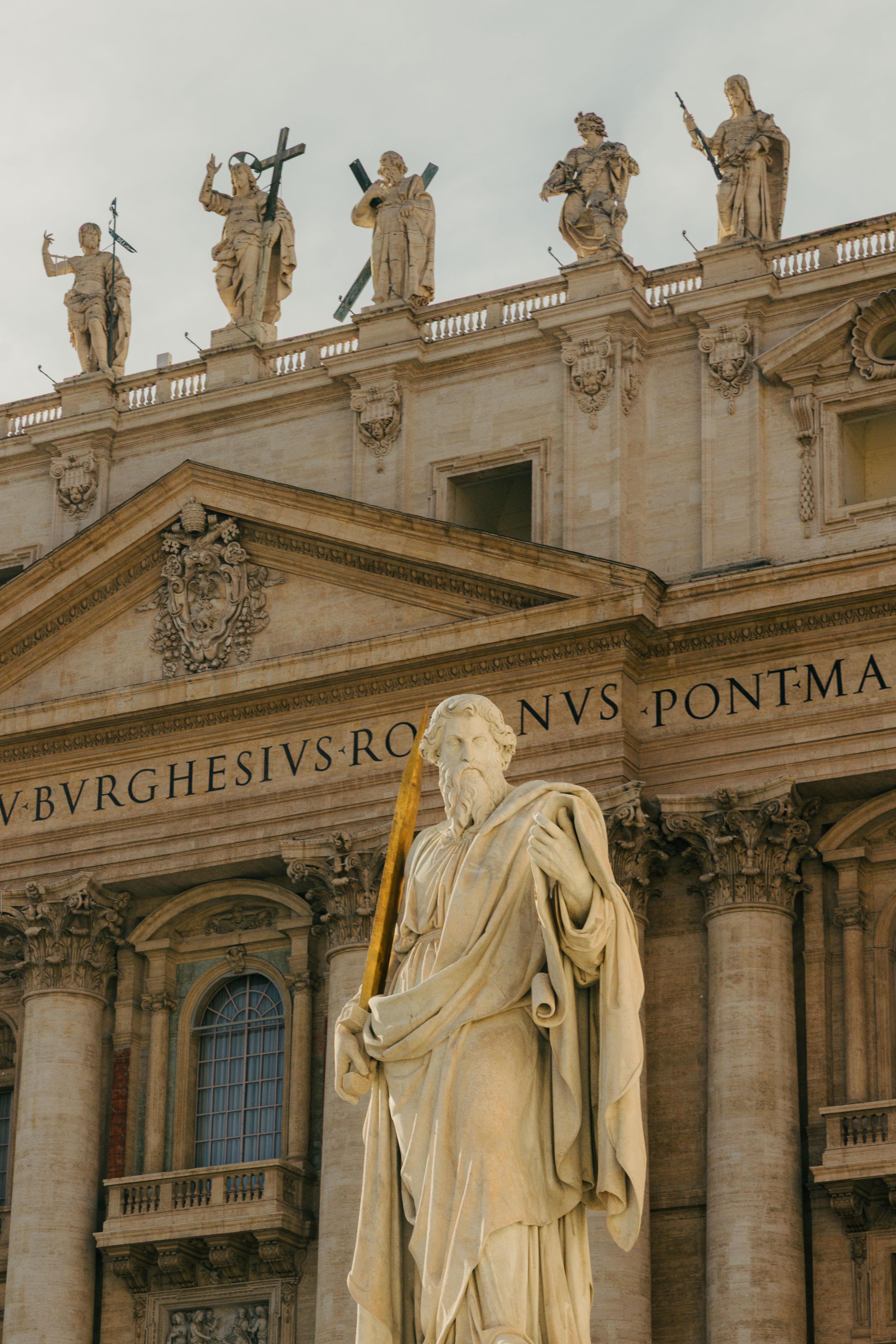 Majestic statue at St. Peter's Basilica, Rome, highlighting classical architecture.