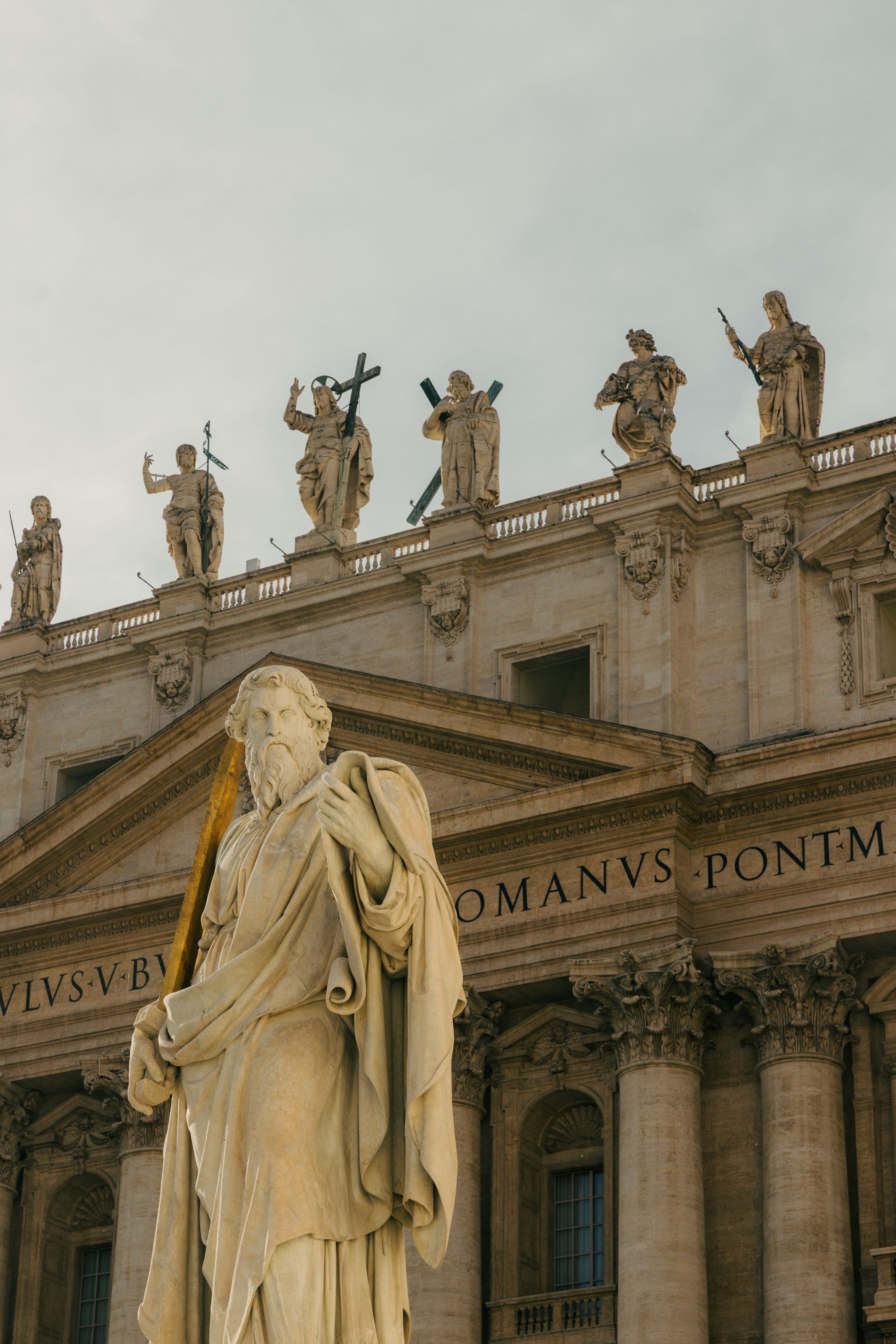 Beautiful statue outside St. Peter's Basilica showcasing classic Roman architecture.