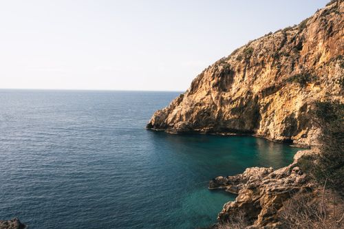 Free Explore the stunning rocky coastline of Hatay, Türkiye, bathed in warm sunlight. Stock Photo