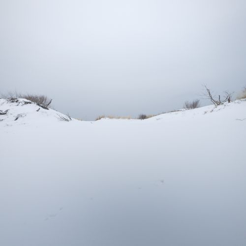 Free A tranquil view of a snow-covered landscape with a cloudy sky. Stock Photo