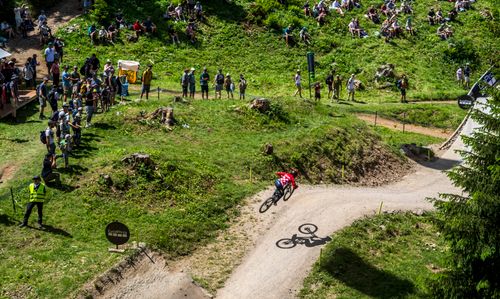 Free Daring mountain bike competition with spectators in Swiss landscape. Stock Photo