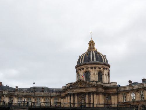 Free A classic view of the Institute of France, showcasing Parisian architectural elegance under a cloudy sky. Stock Photo